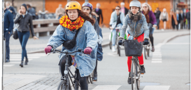 Copenhagen, Denmark - April 28, 2015: People going by bike in the city  A lot of commuters, students and tourists prefer using bike instead of car or bus to move around the city 