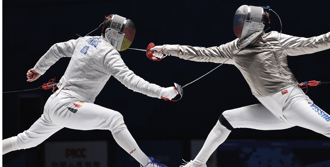 (191021) -- WUHAN, Oct  21, 2019 () -- Richard Huebers (L) of Germany and Konstantin Lokhanov of Russia compete during the men's individual sabre gold medal bout of fencing at the 7th CISM Military World Games in Wuhan, capital of central China's Hubei Province, Oct  21, 2019  ( Wang Jianwei)  